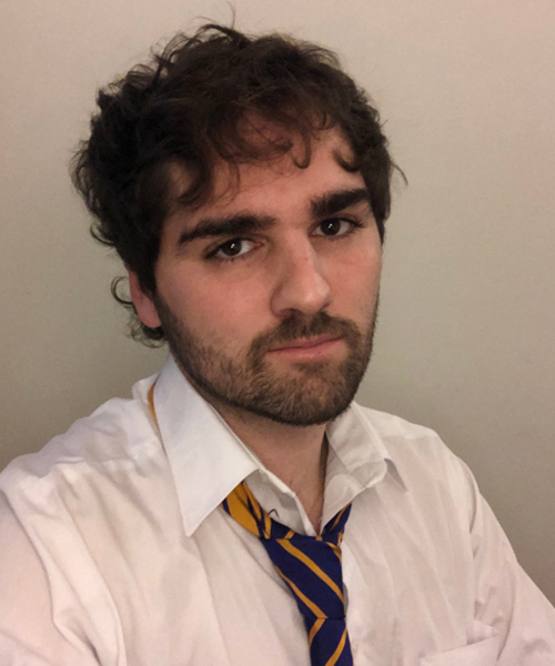 A picture of Pepe Lolo wearing a white shirt and a tie looking into the camera at a slight angle